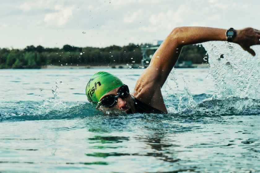 person swimming on body of water